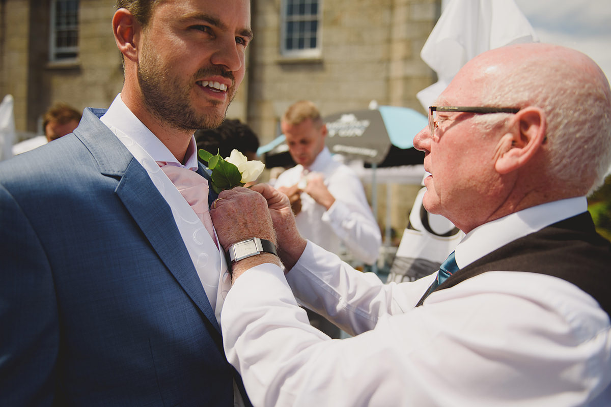 Groom putting on button hole at a Tregenna wedding